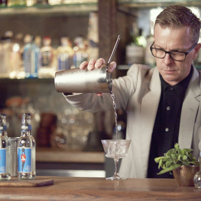 Mikey Enright pouring a cocktail